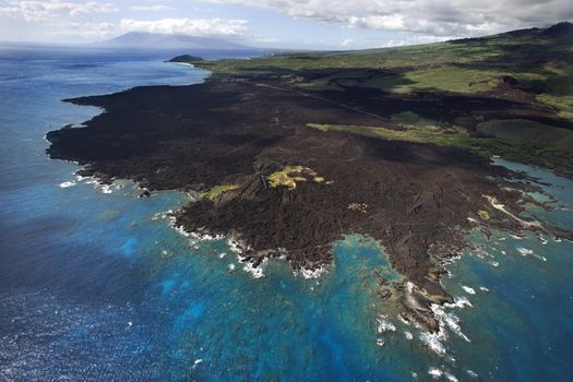 Aerial of Pacific ocean and Maui, Hawaii coast with lava rocks.