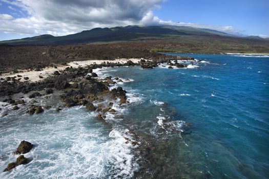 Aerial of Pacific ocean and Maui, Hawaii coast with lava rocks.