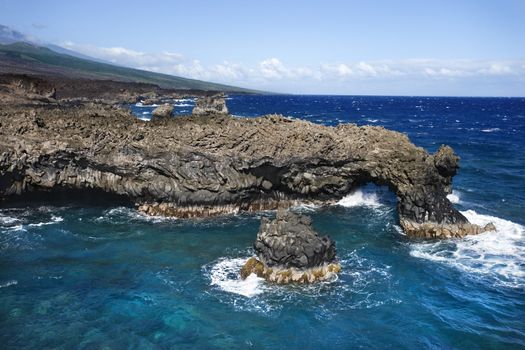 Aerial of Pacific ocean and Maui, Hawaii coast with lava rocks.