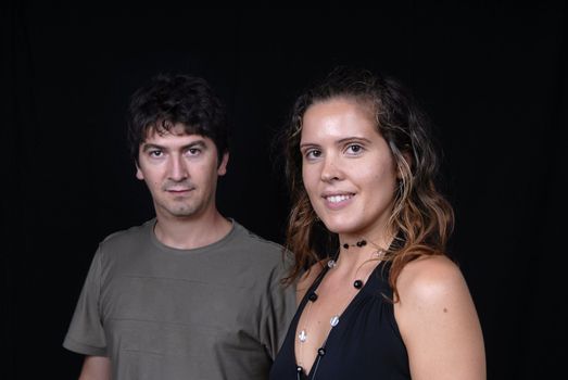 young casual couple portrait in studio shot, focus on the woman