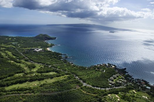 Aerial of coastline with Pacific ocean with island in background in Maui, Hawaii.