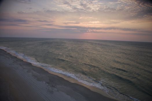 Scenic Bald Head Island North Carolina landscape of shoreline during sunrise.