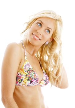 tanned blond in colorful bikini over white background
