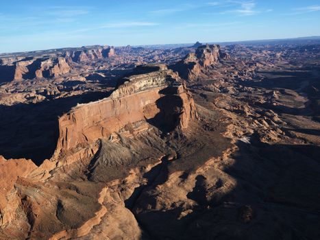 Aerial view of southwest desert with cliffs and rock formations.