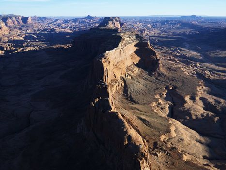 Aerial view of southwest desert with cliffs and rock formations.