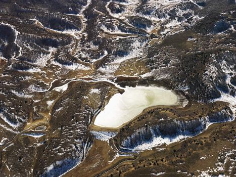 Aerial view of snow covered rural Colorado scenic with lake.