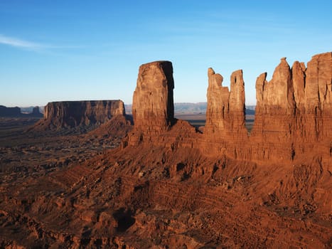 Sandstone mesas and buttes in desert of Monument Valley.