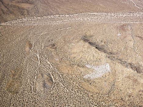 Aerial view of torrid California desert with rocky landforms.