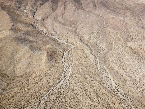 Aerial view of torrid California desert with rocky landforms.