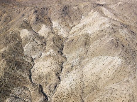 Aerial view of torrid California desert with rocky landforms.