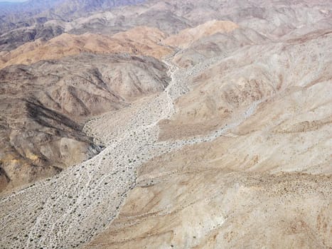 Aerial view of torrid California desert with rocky landforms.