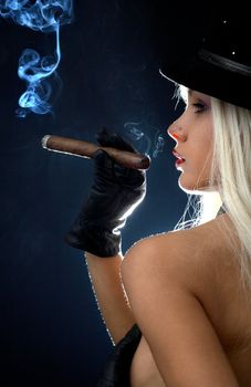 backlight image of topless girl smoking cigar