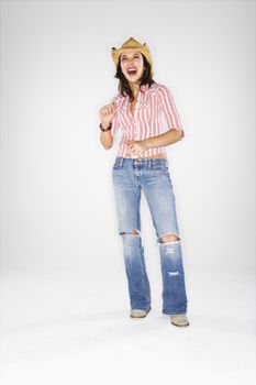 Young adult Caucasian woman wearing cowboy hat laughing.