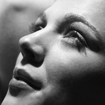 Close-up of young Caucasian woman face looking to side.