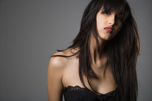 Head and shoulder portrait of pretty young woman with long black hair.