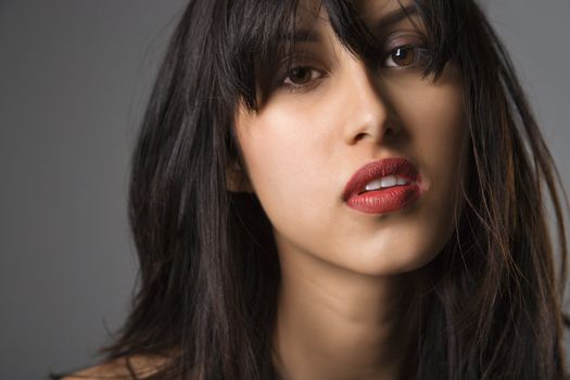 Headshot of pretty young woman with long black hair.