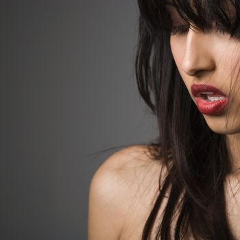 Head and shoulder portrait of pretty young woman with long black hair.