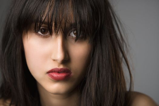 Headshot of pretty young woman with long black hair.