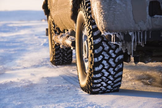 Close up of truck on ice covered road.