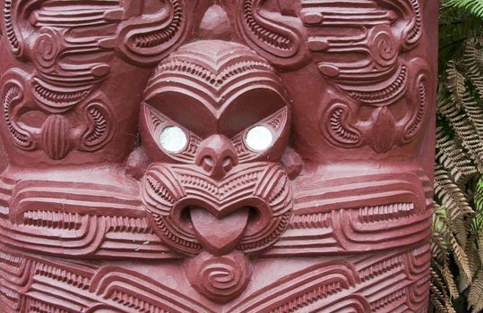 Maori wood carving outside the Maori meeting house at the Treaty Grounds 