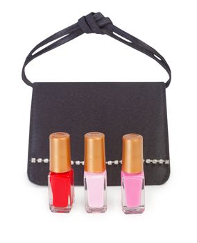 Small black handbag and three vials of nail polish