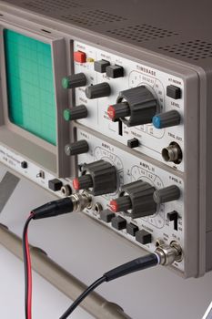 analogue oscilloscope on grey background