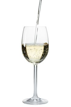 pouring white wine in a glass over a white background