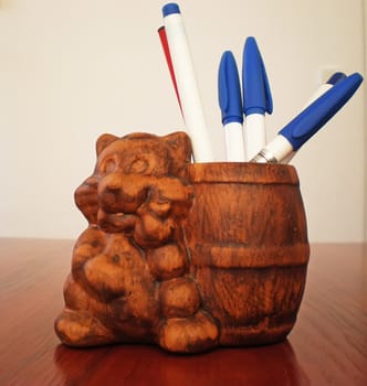brown wooden pen holder on a table