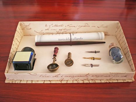 calligraphy ink pen set in a box on wooden table