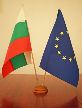 bulgarian and european flags on a wooden table     