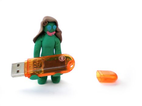plasticine figure of a green woman carry a usb flash 