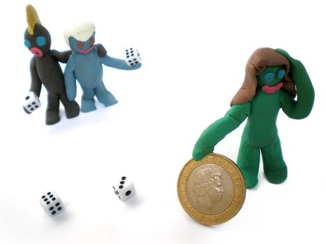 plasticine people figures playing with dice on white background