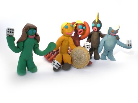 plasticine people figures playing with dice on white background