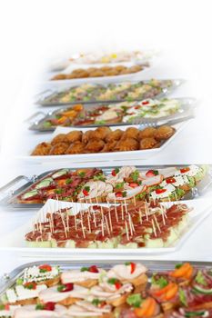Buffet on a long table with appetizers or finger food