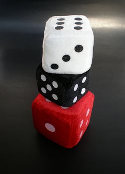 red, white and black dice up in a column     