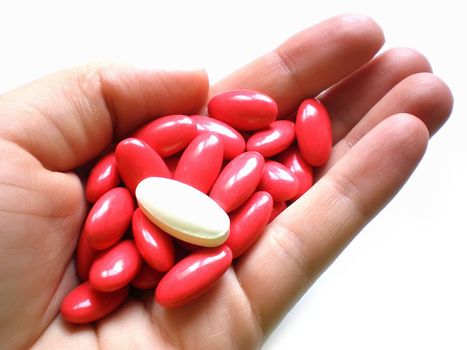 pile of pills in hand isolated on white background