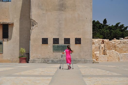 Girl pay tribute to fallen soldiers in Israel, a memorial monument in Latroun.