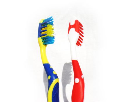 red and blue toothbrushes isolated on white background