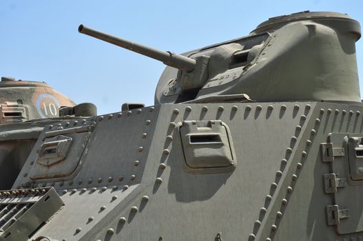 Old tank against the blue sky . Israel, Latrun.