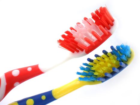 red and blue toothbrushes isolated on white background