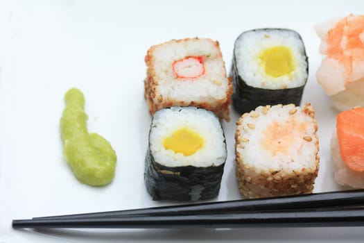 A serving of Japanese Sushi with wasabi and chopsticks