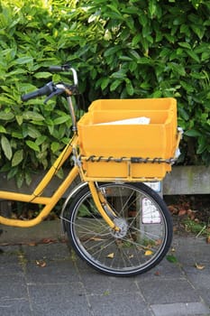 A yellow bicycle, used to deliver the mail