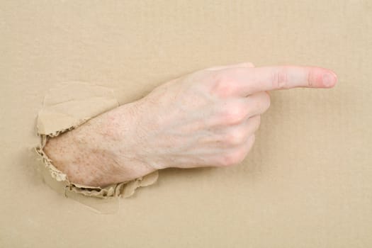 Gesture male hand through from hole in cardboard