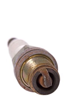 Isolated image of a used spark plug.