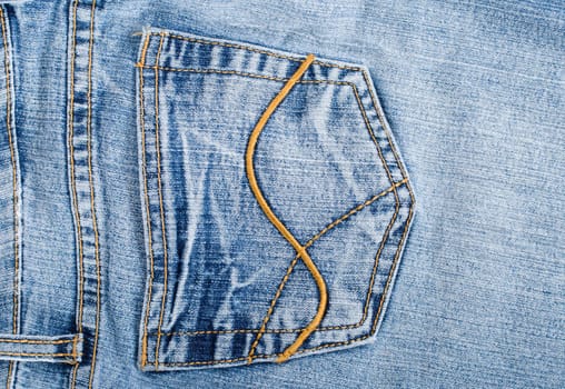 old blue jeans hip pocket texture, macro shot