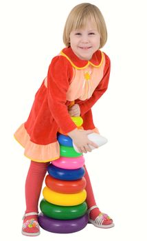 Child in the red dress with toy on a white 