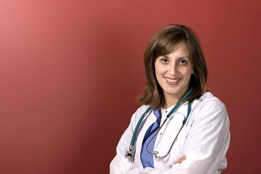 A young medical professional isolated over a red background with copyspace.