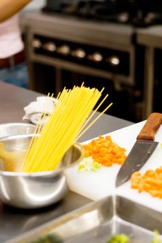 italian spaghetti pasta on a typical full equipped restaurant kitchen