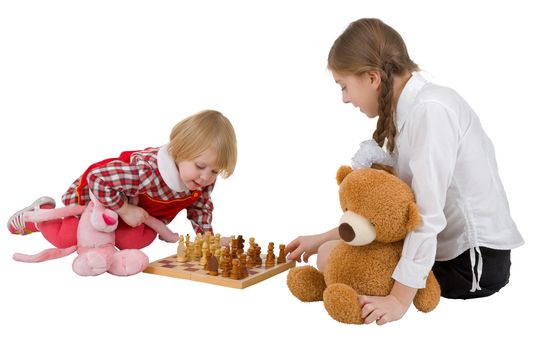 Girls play chess on the white background