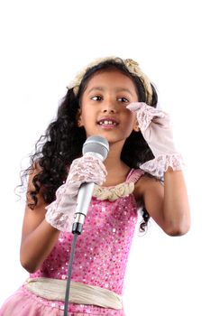 A talented little Indian singer learning performance skills, on white studio background.